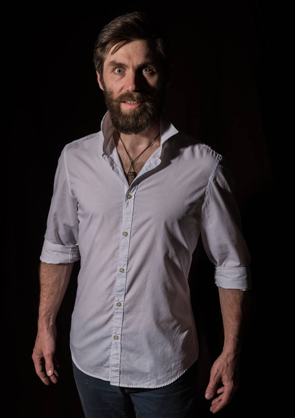 Portrait handsome bearded man, sexy guy on a dark background - Photo, Image