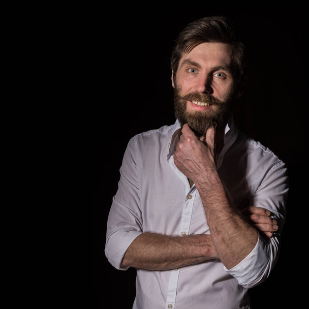 Portrait handsome bearded man, sexy guy on a dark background. free space for text - Foto, Bild