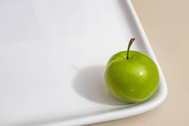 close up green plums in white plate - Photo, Image