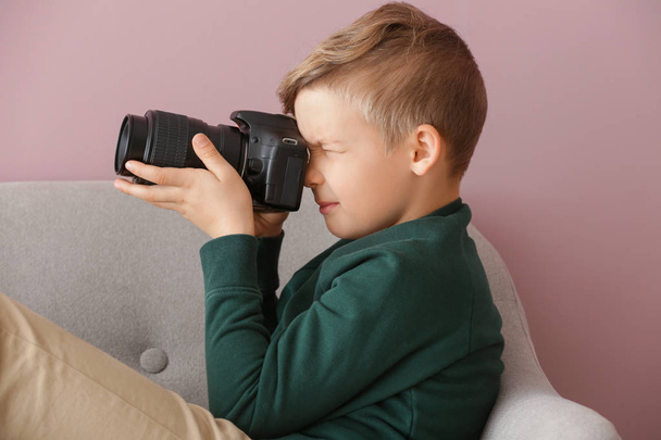 Cute little photographer with professional camera at home - Photo, image