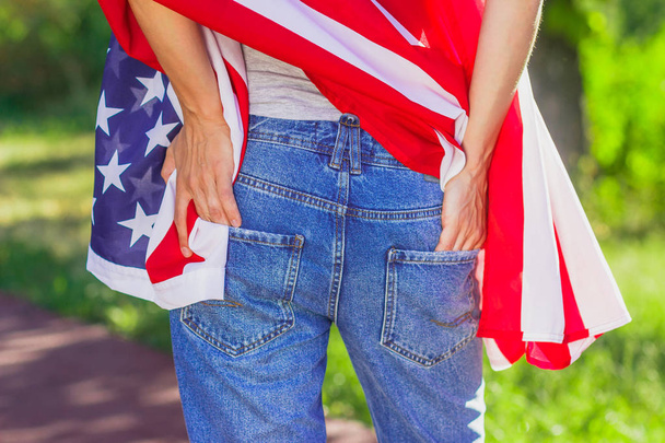 Woman with a flag of United States of America in the hands, outdoors - Фото, зображення