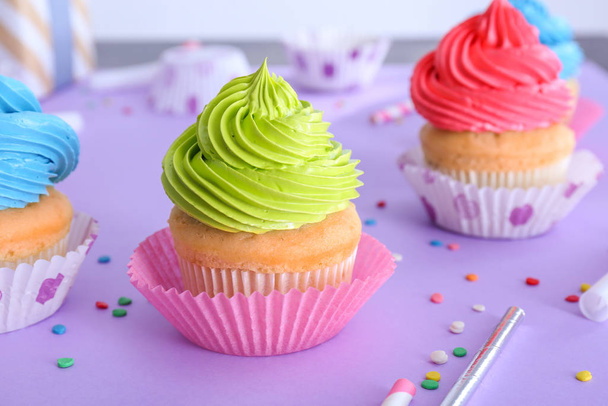 Tasty Birthday cupcakes on color background - Фото, изображение