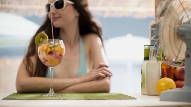 Beautiful woman having a fruit salad at the beach - Felvétel, videó