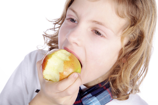 Little boy eating an apple - Фото, зображення