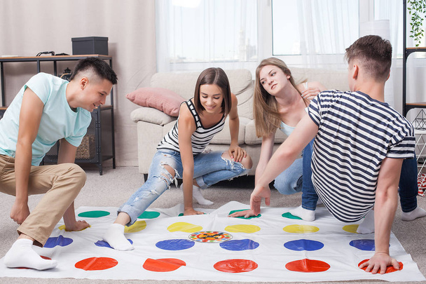 Group of young people playing indoors. Friends having fun. Active games. - 写真・画像