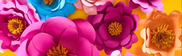 flat lay with paper cut multicolored bright flowers on yellow background - Photo, Image