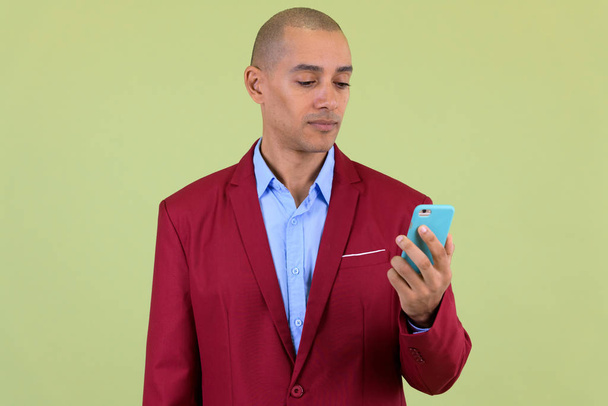 Handsome bald multi ethnic businessman using phone - Photo, Image