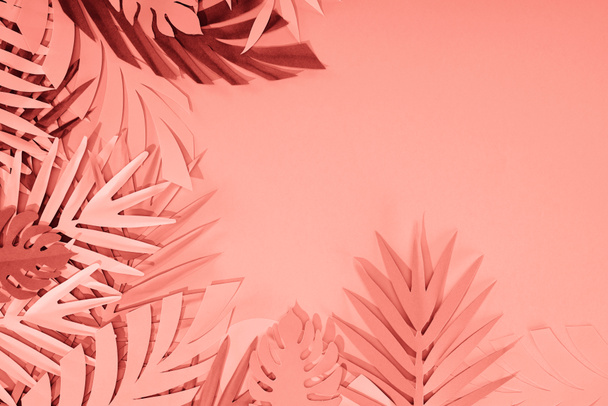 frame of coral tropical paper cut palm leaves, minimalistic background with copy space - Photo, Image