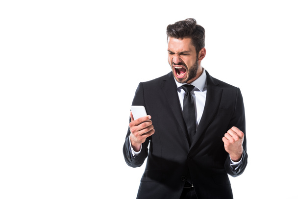 yelling businessman with smartphone and clenched hand Isolated On White - 写真・画像