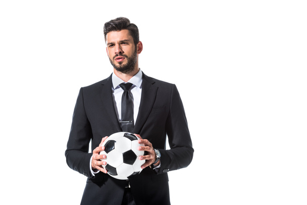 handsome businessman in formal wear holding soccer ball Isolated On White - 写真・画像