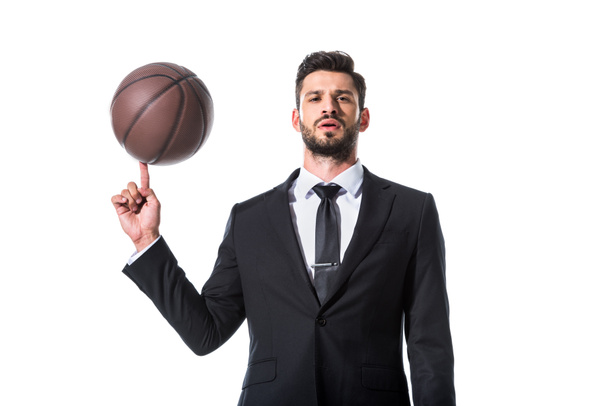 handsome businessman in formal wear spinning on finger basketball Isolated On White - Fotografie, Obrázek