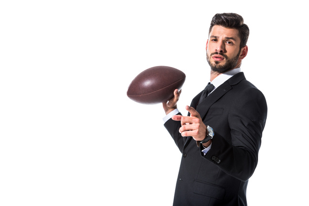 biznesmen w formalnym noszeniu z piłką do rugby z palcem izolowane na białym - Zdjęcie, obraz