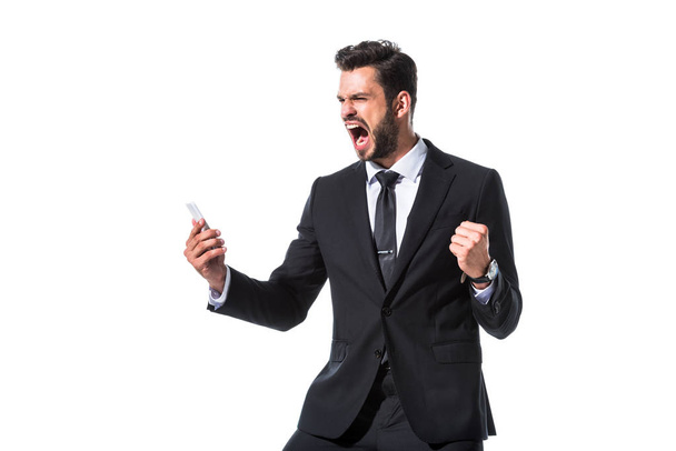 shouting businessman with smartphone and clenched hand Isolated On White - Photo, Image