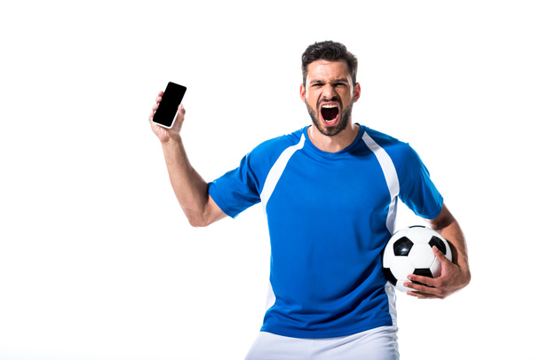 ενθουσιασμένος παίκτης ποδοσφαίρου με μπάλα και smartphone με κενή οθόνη απομονωμένη σε λευκό - Φωτογραφία, εικόνα