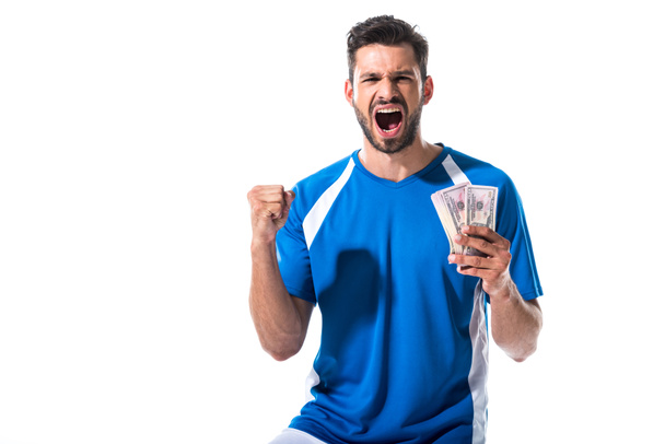voetballer juichen met dollar bankbiljetten geïsoleerd op wit - Foto, afbeelding