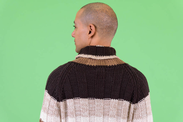 Rear view of bald multi ethnic man ready for winter - Фото, изображение
