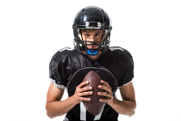 Americký fotbalový hráč v helmě s koulí izolovaný on White - Fotografie, Obrázek