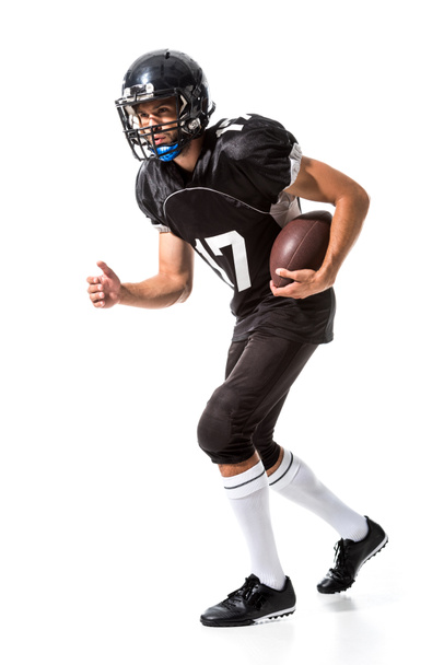 Joueur de football américain en unifom avec ballon isolé sur blanc
 - Photo, image