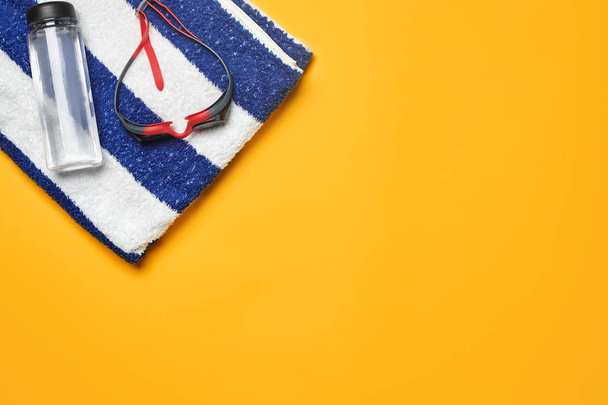 Flat lay summer pool accessories on a yellow background. Colorful beach wear. - Fotoğraf, Görsel