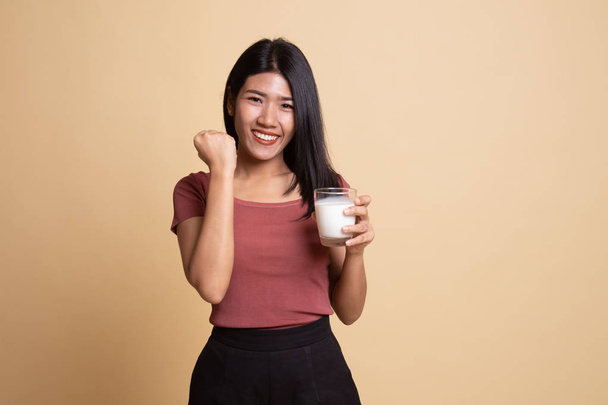 Healthy Asian woman drinking a glass of milk. - Photo, image