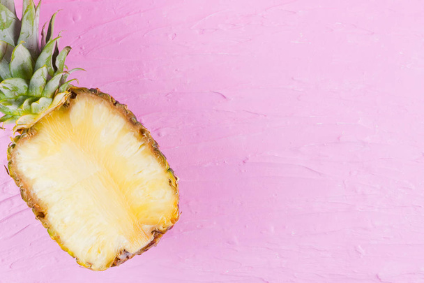 Pineapple on a pink background. Half of pineapple on a pastel background. Tropical fruit in a pop art style. Minimalism. Copy space - Foto, Imagem