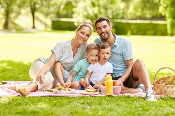 portrait of family having picnic at summer park - 写真・画像