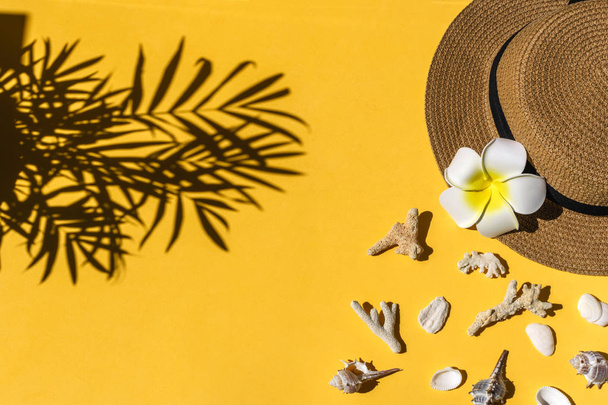 Straw hat, sea shells on bright yellow background, copy space - Photo, Image
