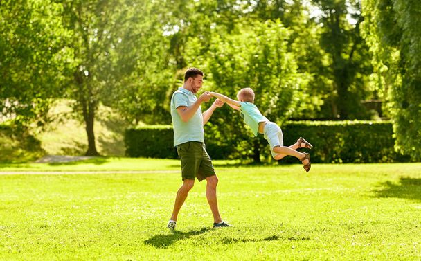 happy father and son having fun at summer park - Valokuva, kuva