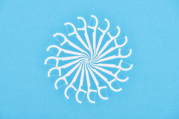top view of white floss toothpicks isolated on blue  - Fotografie, Obrázek