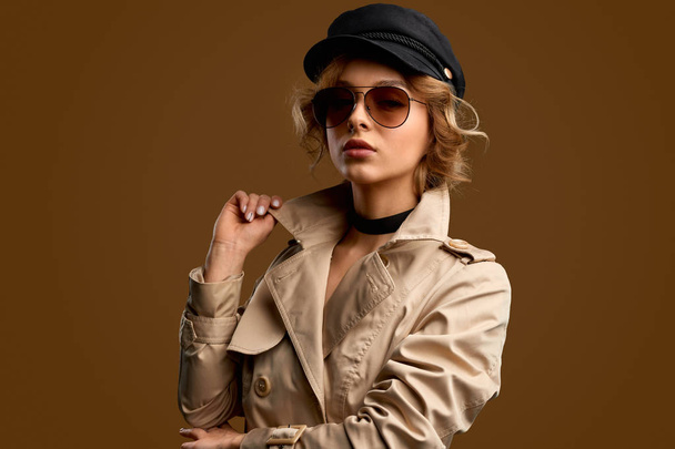 Trendy woman touching collar of coat - Valokuva, kuva