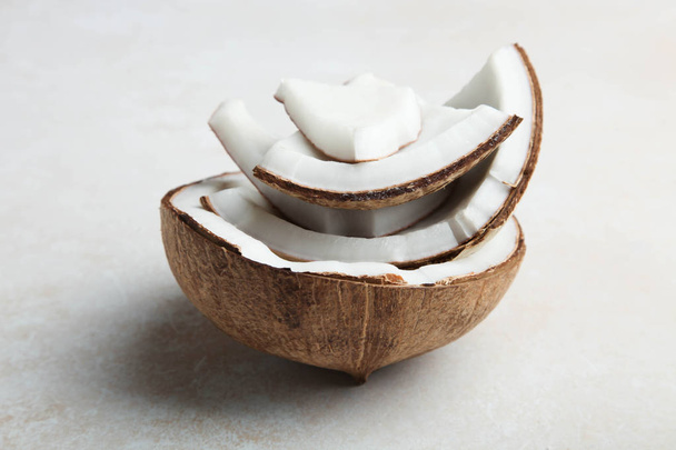 Pieces of broken natural exotic coconut  - Fotó, kép