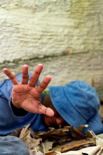 selective focus of Homeless dirty hand in abandoned house. Him He tried to raise his hand to prevent danger from physical abuse. concept for violence, terrified and Human Rights - Fotografie, Obrázek
