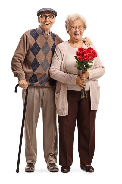 Senior couple standing with red roses  - Zdjęcie, obraz