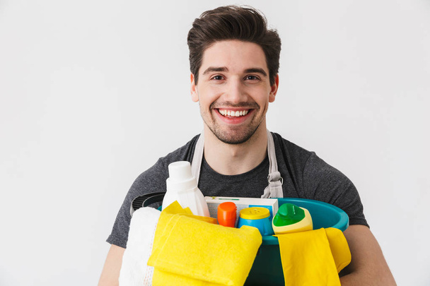 Handsome brunette houseman wearing apron - Photo, Image