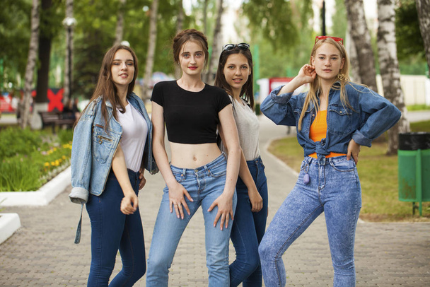 Four schoolgirls in summer park - Foto, afbeelding