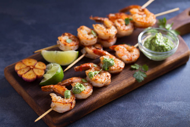 Cilantro lime grilled shrimps. Shrimps on skewers with garlic butter sauce - Photo, Image