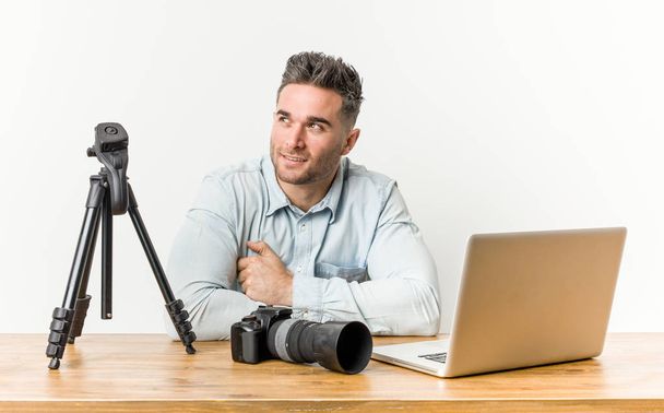 Young handsome photography teacher smiling confident with crossed arms. - Photo, Image