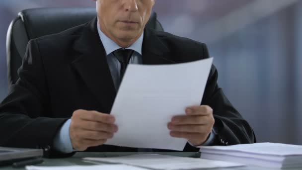 Senior male manager working on documents, reading contract details, politician - Filmati, video