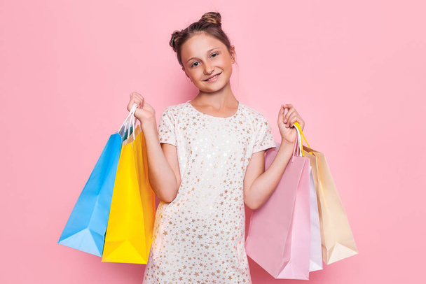 girl in stylish dress, teenager with purchases in hands, after s - Fotografie, Obrázek