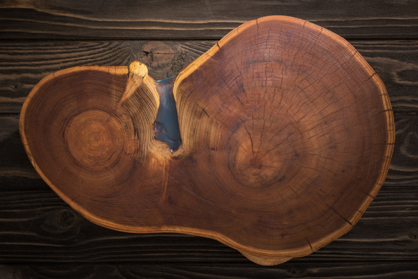 top view of wooden cutting board on brown table  - 写真・画像