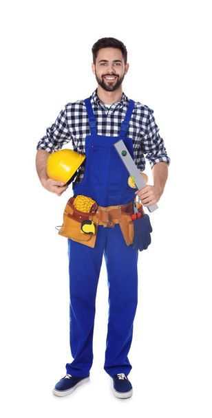 Full length portrait of construction worker with tool belt on white background - Fotoğraf, Görsel