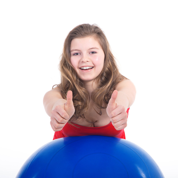 Sportive woman exercising with a Swiss ball - Foto, imagen