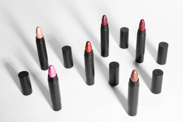 Set of bright lipsticks in black tubes on white background - Valokuva, kuva