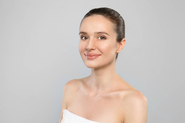 Portrait of beautiful young woman with perfect skin on grey background. Spa treatment - Fotó, kép