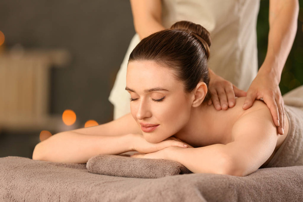 Beautiful young woman enjoying massage in spa salon - Valokuva, kuva
