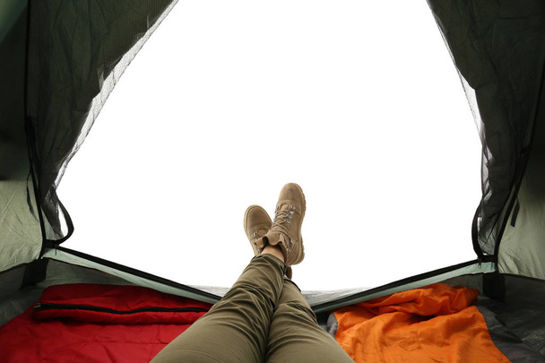 Closeup of female in camping tent on white background, view from inside - Фото, изображение
