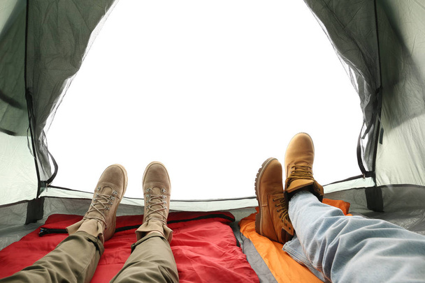Closeup of couple in camping tent on white background, view from inside - Foto, afbeelding