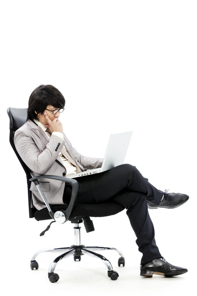 Young business man using new laptop and thinking - Φωτογραφία, εικόνα