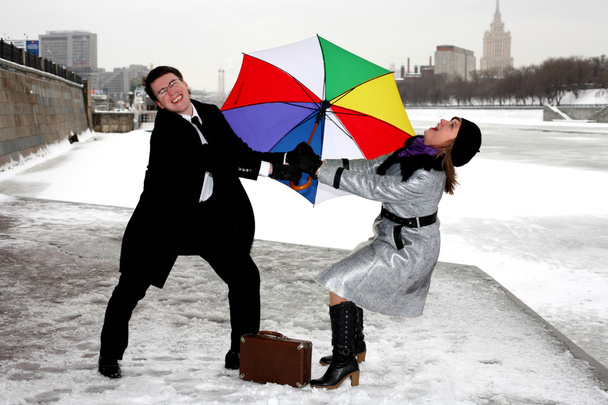 Girl and man fighting with umbrella - Zdjęcie, obraz