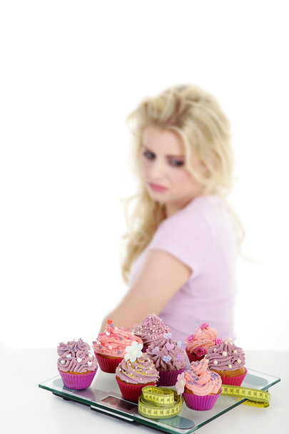 Young smiling woman with cupcake - Foto, imagen